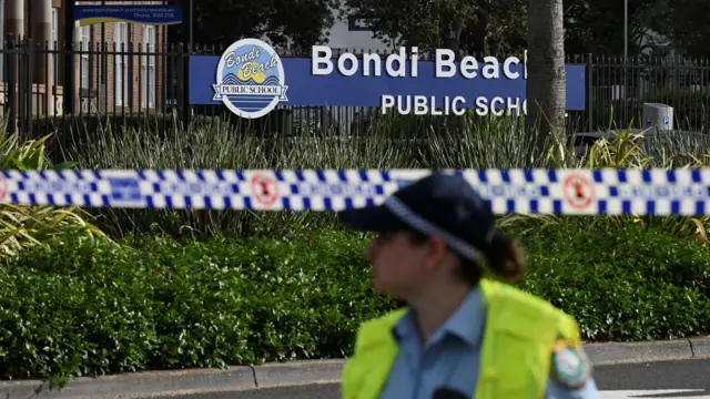 A police officer stands guard following the attack on a Jewish holiday celebration at Sydney's Bondi Beach