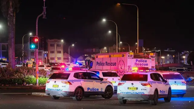 Police cars and vans are seen parked up near Bondi Beach