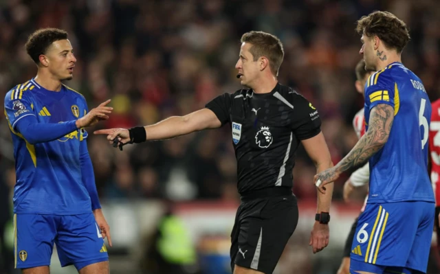 Referee John Brooks awards a penalty