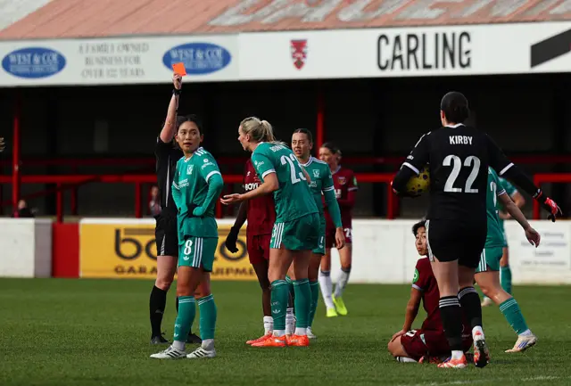 Gemma Bonner of Liverpool is shown a red card by referee Abigail Byrne