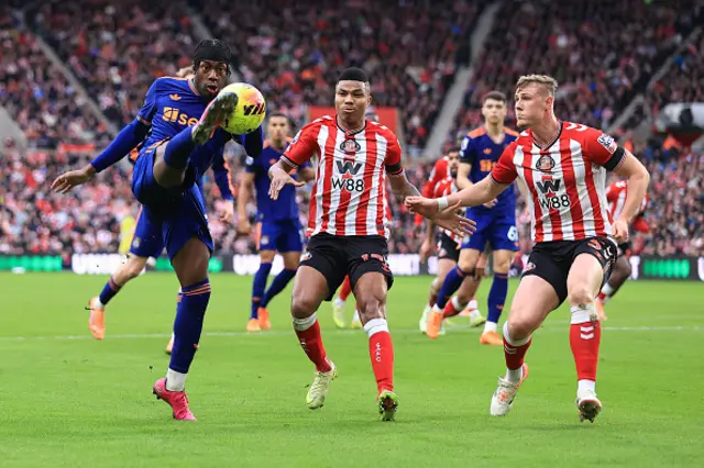 Anthony Elanga of Newcastle United battles with Reinildo Mandava of Sunderland (C) and Daniel Ballard of Sunderland