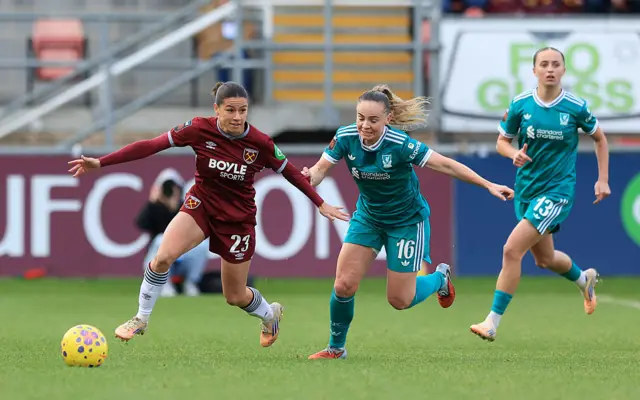 Ffion Morgan of West Ham United is put under pressure by Lily Woodham of Liverpool
