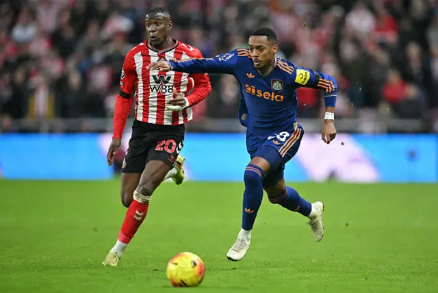 Joe Willock (R) fends off a challenge from Sunderland's French defender Nordi Mukiele