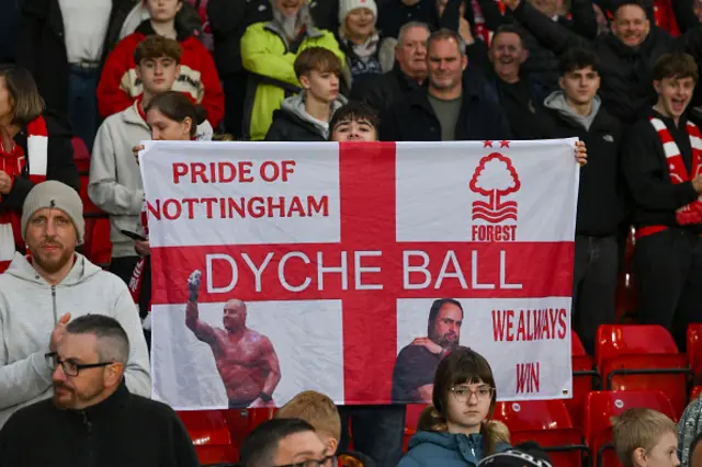 A Forest fan holds a banner supporting head coach Sean Dyche and Nottingham Forest owner Evangelos Marinakis
