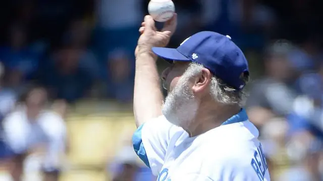 Reiner with his arm raised throwing a pitch while wearing a Dodgers jersey