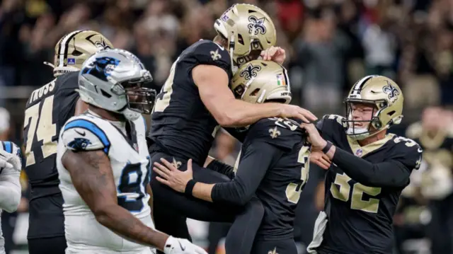 The New Orleans Saints celebrate after Charlie Smyth's game-winning field goal against the Carolina Panthers