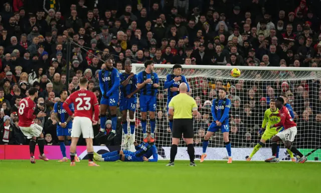 Manchester United's Bruno Fernandes scores their side's third goal of the game during the Premier League match at Old Trafford,