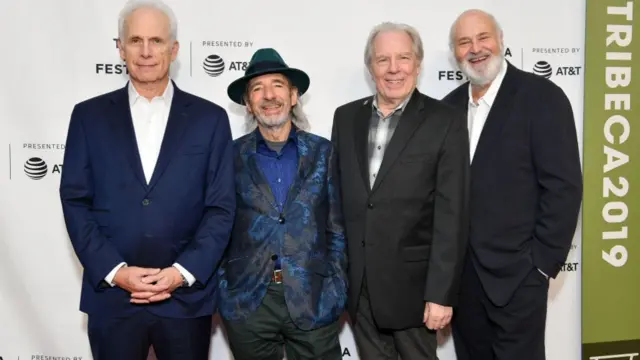 Harry Shearer (middle left) alongside Rob Reiner (right) and the cast of "Spinal Tap II" pose for a photo