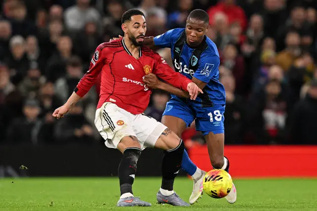Bournemouth's French defender #18 Bafode Diakite (R) tackles Manchester United's Brazilian striker #10 Matheus Cunha (L) during the English Premier League football match between Manchester United and Bournemouth at Old Trafford