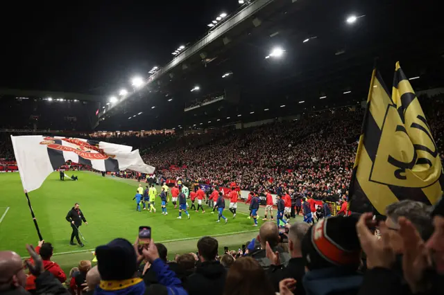 Manchester United and Bournemouth players make their way out onto the pitch p