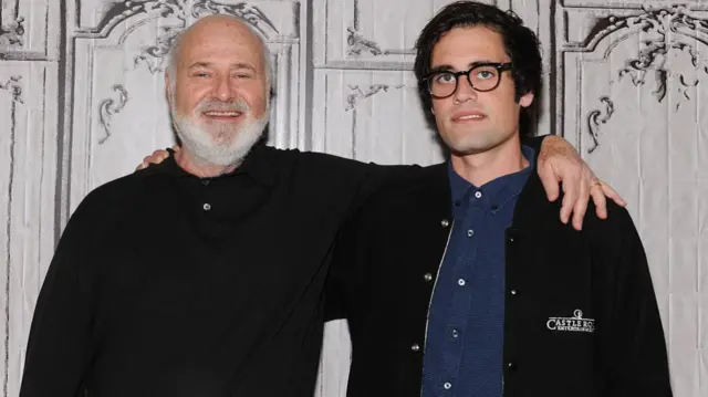 Rob Reiner (left) with his son Nick Reiner. Both wear black and smile. Rob has his arm around Nick
