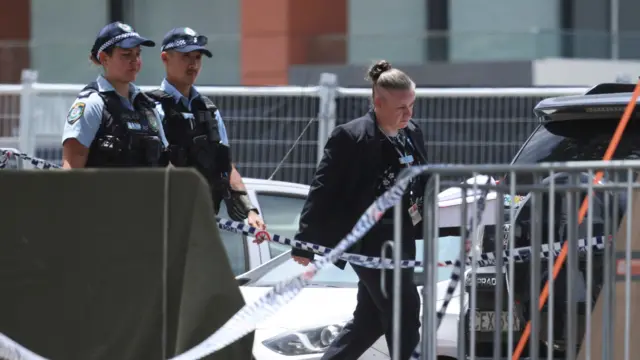 Police officers enter a tent at the scene of a shooting during a Jewish holiday celebration at Bondi Beach, in Sydney, Australia, December 15, 202