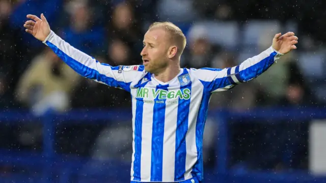 Sheffield Wednesday captain Barry Bannan holding his arm stretched out
