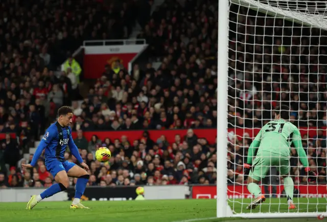 Marcus Tavernier of Bournemouth (L) in action against goalkeeper Senne Lammens of Manchester United