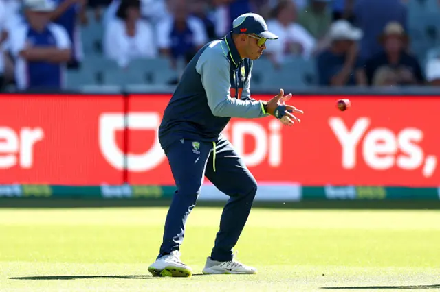Usman Khawaja of Australia warms up during day one