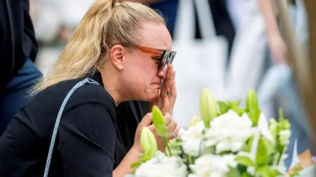 A woman mourns at a memorial in Sydney