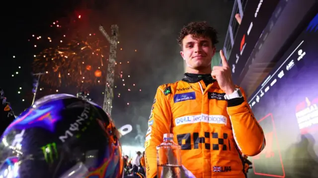Lando Norris celebrates after victory in Singapore
