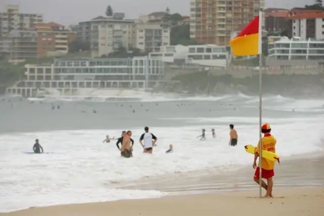 A volunteer surf life saver at watchers swimmers at Bondi.