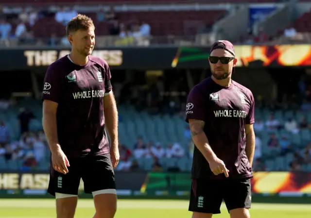 England's Joe Root and head coach Brendon McCullum before the match
