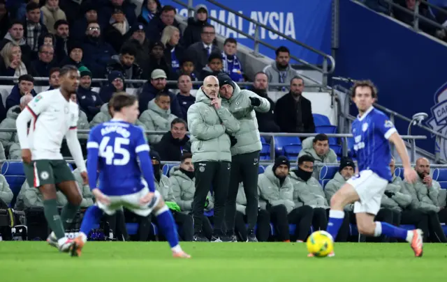 Enzo Maresca, Manager of Chelsea, and Danny Walker, First Team Coach of Chelsea, watch on from the technical area during the Carabao Cup Quarter Final match between Cardiff City and Chelsea at Cardiff City Stadium.