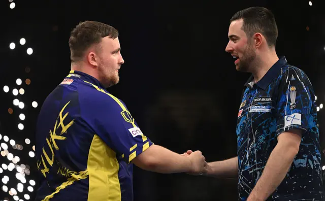 Luke Littler shakes hands with Luke Humphries