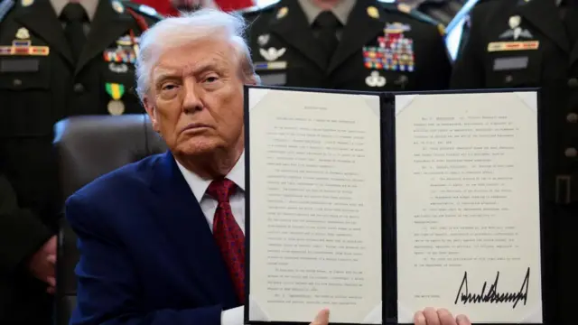 President Donald Trump holding up the executive order he signed on Monday declaring fentanyl a "weapon of mass destruction"|