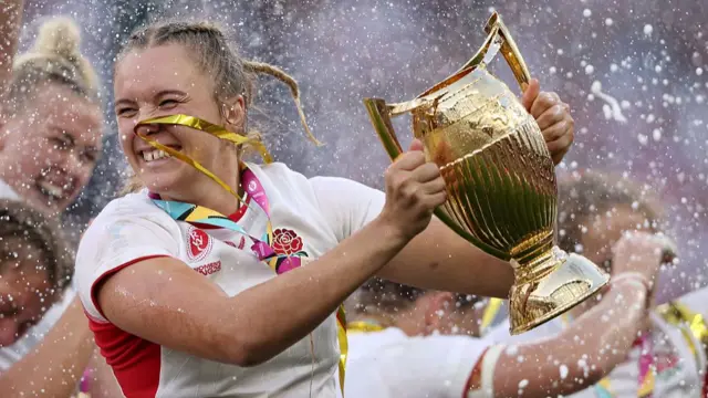 Zoe Aldcroft lifts the Women's Rugby World Cup trophy