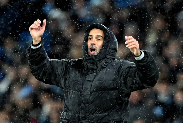 Pep Guardiola in the rain