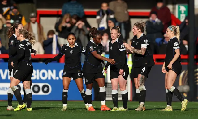 Players of Chelsea celebrate their team's second goal, scored from an own goal by Caitlyn Hayes of Brighton & Hove Albion (not pictured) during the Barclays Women's Super League match between Brighton & Hove Albion and Chelsea FC at Broadfield Stadium on December 14, 2025