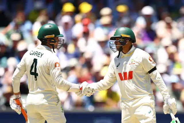 Usman Khawaja celebrates his half-century by shaking Usman Khawaja's hand