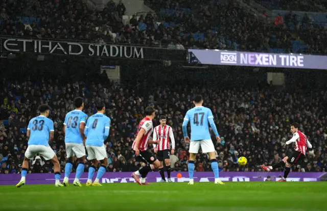 Brentford's Mathias Jensen (right) attempts a freekick