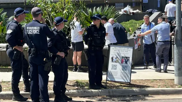 Police and mourners gather outside the chabad