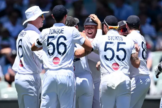 England congratulate Brydon Carse for his catch to dismiss Cameron Green