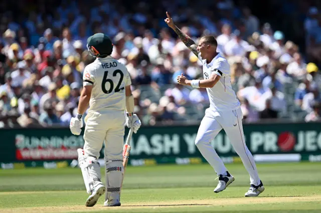 Brydon Carse celebrates the wicket of Travis Head