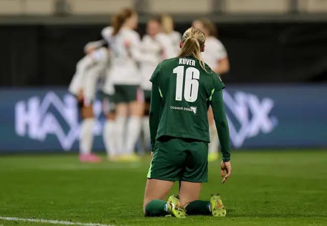 Wolfsburg player on their knees after Chelsea score