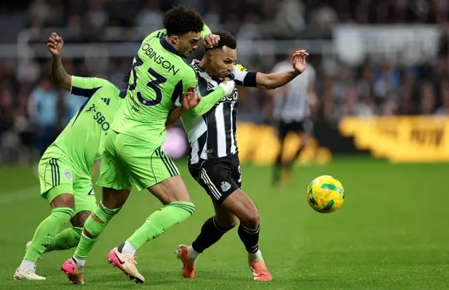 Jacob Murphy of Newcastle United is challenged for the ball by Antonee Robinson