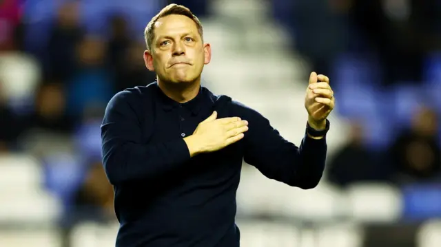 Reading boss Leam Richardson taps his chest in front of fans just before kick-off