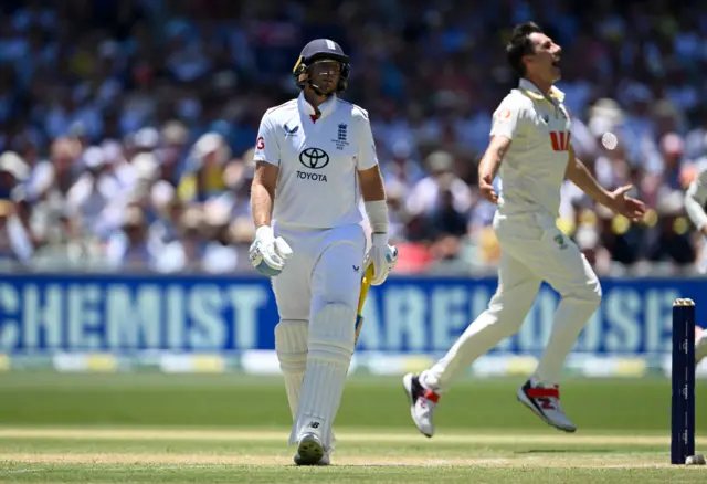 Joe Root looks dejected as Pat Cummins celebrates