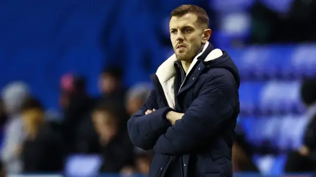 Luton manager Jack Wilshere looks pensive on the touchline