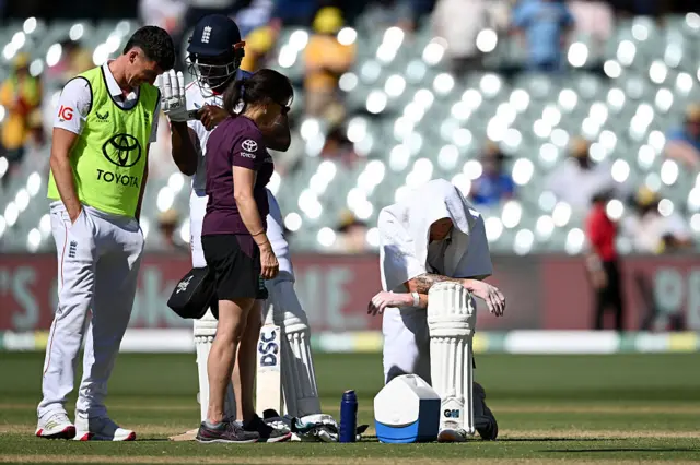Ben Stokes has a cold towel on his head during a drinks break