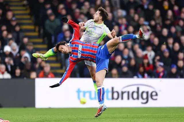 Daichi Kamada and Nico gonzalez go for the ball