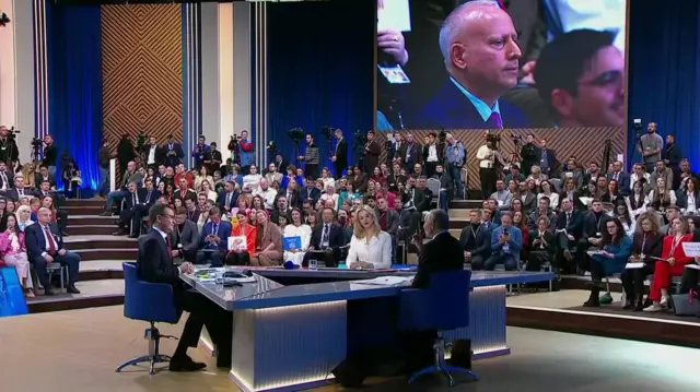 Steve Rosenberg on a screen above Putin's news conference