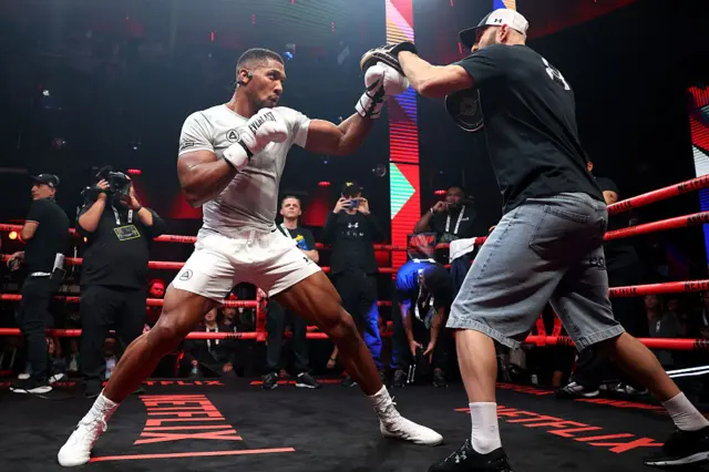 Anthony Joshua throws a punch at a pad