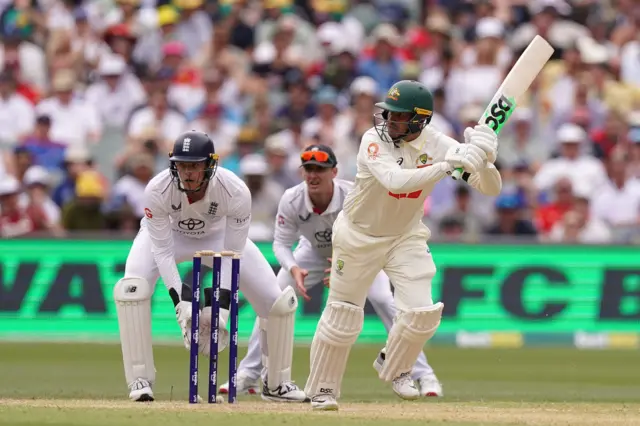 Australia's Usman Khawaja (right) bats as England’s Jamie Smith (left) and Harry Brook (centre) watch from behind the stumps on day three of the third NRMA Insurance Ashes Series 2025 test at the Adelaide Oval, Australia