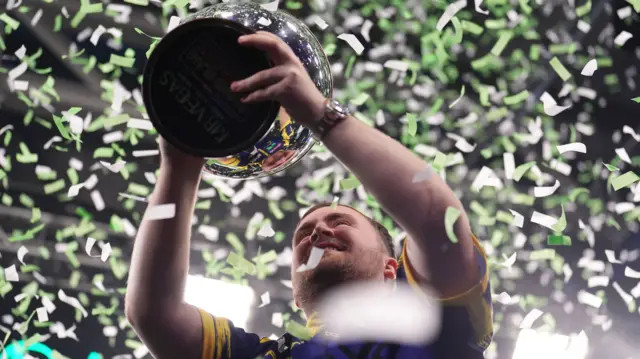 Luke Littler holds the Grand Slam trophy