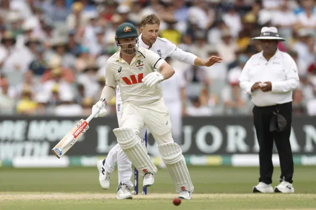 Joe Root and Travis Head avoid a collision