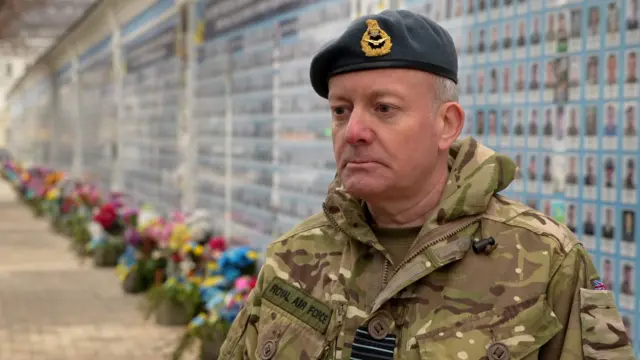 Sir Richard Knighton in military fatigues and beret.