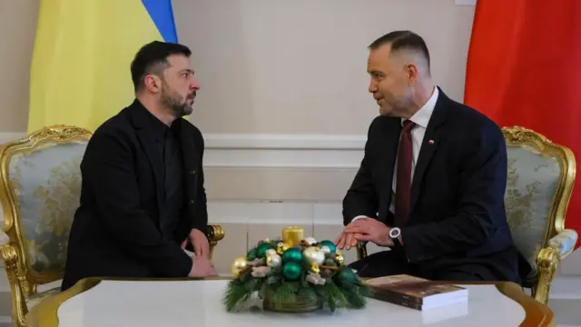 Ukrainian President Volodymyr Zelensky, left, sits with Polish President Karol Nawrocki, right, in an ornate setting.