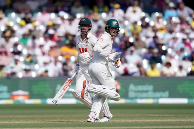 Travis Head and Alex Carey run between the wickets