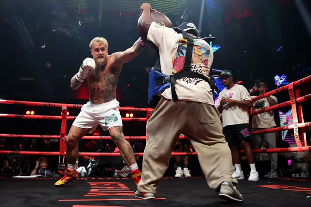 Jake Paul throws a punch at a pad